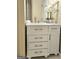 Bathroom vanity with white marble top, drawers and cabinet, chrome faucet, and decorated with a white orchid at 110 Vicarage Ct, Johns Creek, GA 30005