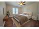 Cozy bedroom features a ceiling fan, shuttered window, and comfortable furnishings and decor at 110 Vicarage Ct, Johns Creek, GA 30005