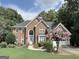 Beautiful two-story brick home with a well-manicured lawn and lush landscaping at 110 Vicarage Ct, Johns Creek, GA 30005