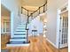 Inviting foyer showcasing hardwood floors and a staircase with dark wood banister at 110 Vicarage Ct, Johns Creek, GA 30005