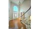 Two-story foyer featuring hardwood floors, large window, and elegant chandelier at 110 Vicarage Ct, Johns Creek, GA 30005