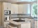 Bright kitchen featuring white cabinetry, granite countertops, and stainless steel appliances at 110 Vicarage Ct, Johns Creek, GA 30005