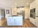 Spacious kitchen features an island with cooktop, white cabinets, and stainless steel appliances at 110 Vicarage Ct, Johns Creek, GA 30005
