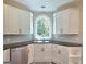 Corner kitchen showcasing a deep sink, granite counters and white cabinetry at 110 Vicarage Ct, Johns Creek, GA 30005
