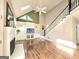 Spacious living room featuring fireplace, built-in shelving, and hardwood floors at 110 Vicarage Ct, Johns Creek, GA 30005
