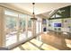 Open living space, hardwood floors, and doors opening to the deck area with wooded backyard views at 110 Vicarage Ct, Johns Creek, GA 30005