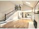 Hardwood floors with view to kitchen and fireplace with bright stairwell and open living space at 110 Vicarage Ct, Johns Creek, GA 30005
