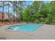 Outdoor swimming pool with plenty of lounge seating for residents in a wooded community at 110 Vicarage Ct, Johns Creek, GA 30005