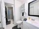 Bright bathroom featuring a tiled floor, toilet, vanity, mirror, and an over-the-toilet cabinet for storage at 120 Williamsburg Way, Fayetteville, GA 30214