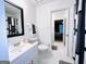 Bright bathroom featuring a modern vanity, white tile flooring, updated fixtures, and contemporary decor at 120 Williamsburg Way, Fayetteville, GA 30214