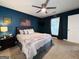 Stylish bedroom with a bed, ceiling fan, moody paint, natural light, and modern decor at 120 Williamsburg Way, Fayetteville, GA 30214