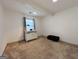 Cozy carpeted bedroom featuring a white cabinet under the window and a dark trunk on the side at 120 Williamsburg Way, Fayetteville, GA 30214