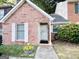 Charming brick home featuring a welcoming front door with a decorative wreath and well-maintained landscaping at 120 Williamsburg Way, Fayetteville, GA 30214