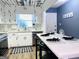 Eat-in kitchen featuring white cabinets, stainless steel appliances, subway tile backsplash, and bar stool seating at 120 Williamsburg Way, Fayetteville, GA 30214