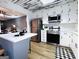 Updated kitchen with stainless steel appliances, subway tile backsplash, white cabinets, and a breakfast bar at 120 Williamsburg Way, Fayetteville, GA 30214