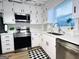 Bright kitchen featuring white cabinets, stainless steel appliances, subway tile backsplash, and modern countertops at 120 Williamsburg Way, Fayetteville, GA 30214