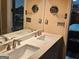 Double sink bathroom vanity with updated fixtures, framed mirror and ample counter space at 2585 Old Jackson Rd, Locust Grove, GA 30248
