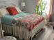 Cozy bedroom with patterned bedding, white metal bed frame, and lots of natural light at 2585 Old Jackson Rd, Locust Grove, GA 30248