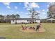 Spacious backyard featuring a charming fire pit area perfect for outdoor entertaining at 4739 Lower Jersey Rd, Oxford, GA 30054