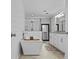 Modern bathroom with a freestanding tub, a glass shower, and sleek white cabinetry at 4739 Lower Jersey Rd, Oxford, GA 30054