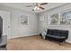 Well-lit room featuring a ceiling fan and neutral tones, with a black futon for relaxation at 4739 Lower Jersey Rd, Oxford, GA 30054