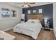 Cozy bedroom featuring a wood accent wall, ceiling fan, and a plush bed at 4739 Lower Jersey Rd, Oxford, GA 30054