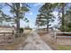 Gated driveway leading to a beautiful home and additional structures on the property at 4739 Lower Jersey Rd, Oxford, GA 30054