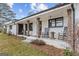 Charming white brick home featuring a rocking chair front porch with rustic wood columns at 4739 Lower Jersey Rd, Oxford, GA 30054
