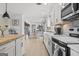 Open concept kitchen with white cabinets, wood counters, and breakfast bar seating with dining area at 4739 Lower Jersey Rd, Oxford, GA 30054
