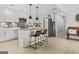 Bright kitchen featuring white cabinets, stainless steel appliances, and a center island with bar seating at 4739 Lower Jersey Rd, Oxford, GA 30054