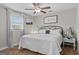 Comfortable bedroom with a ceiling fan, natural light, and a decorative aesthetic at 4739 Lower Jersey Rd, Oxford, GA 30054
