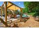 Backyard patio with outdoor dining, adirondack chairs, and pool at 3707 Lance Bluff Ln, Duluth, GA 30097