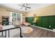 Bright bedroom features stylish paneling, a ceiling fan, and charming decor at 3707 Lance Bluff Ln, Duluth, GA 30097