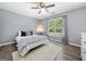 Cozy bedroom with natural lighting, neutral decor and plush bedding at 3707 Lance Bluff Ln, Duluth, GA 30097