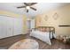 Bedroom with a ceiling fan, closet and decorative artwork at 3707 Lance Bluff Ln, Duluth, GA 30097