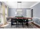 Dining room features a large wooden table, modern chandelier, and soft natural light at 3707 Lance Bluff Ln, Duluth, GA 30097