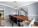 Dining room featuring modern chandelier with wood table, seating for six, and stairs at 3707 Lance Bluff Ln, Duluth, GA 30097