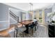 Dining room featuring modern chandelier and a stairway to the second floor at 3707 Lance Bluff Ln, Duluth, GA 30097