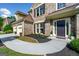 Inviting front entrance with walkway, black mulch landscaping, and three car garage at 3707 Lance Bluff Ln, Duluth, GA 30097