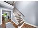 Open foyer featuring wood staircase, hardwood floors, and abundant natural light at 3707 Lance Bluff Ln, Duluth, GA 30097