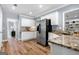 Bright kitchen featuring stainless steel refrigerator, granite countertops, and white cabinets at 3707 Lance Bluff Ln, Duluth, GA 30097