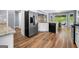 Well-lit kitchen featuring stainless steel appliances and wood flooring at 3707 Lance Bluff Ln, Duluth, GA 30097