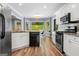 Modern kitchen with stainless steel appliances, granite countertops, and a view of the backyard at 3707 Lance Bluff Ln, Duluth, GA 30097