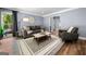 Relaxing living room features gray couch, hardwood floors and neutral decor at 3707 Lance Bluff Ln, Duluth, GA 30097