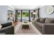 Comfortable living room features a plush gray sofa, large windows, and stylish decor at 3707 Lance Bluff Ln, Duluth, GA 30097