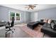 Comfortable living room with home office setup, plush furniture, and large window at 3707 Lance Bluff Ln, Duluth, GA 30097