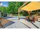 Outdoor patio with dining area, pergola, and inground swimming pool surrounded by lush landscaping at 3707 Lance Bluff Ln, Duluth, GA 30097