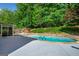 Backyard pool with stone surround and landscaping at 3707 Lance Bluff Ln, Duluth, GA 30097