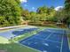 Aerial view of well-maintained blue and green tennis courts at 3707 Lance Bluff Ln, Duluth, GA 30097
