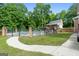 Beautiful backyard pool with surrounding greenery, deck and black metal fence at 604 Clearwater Ct, Mcdonough, GA 30252